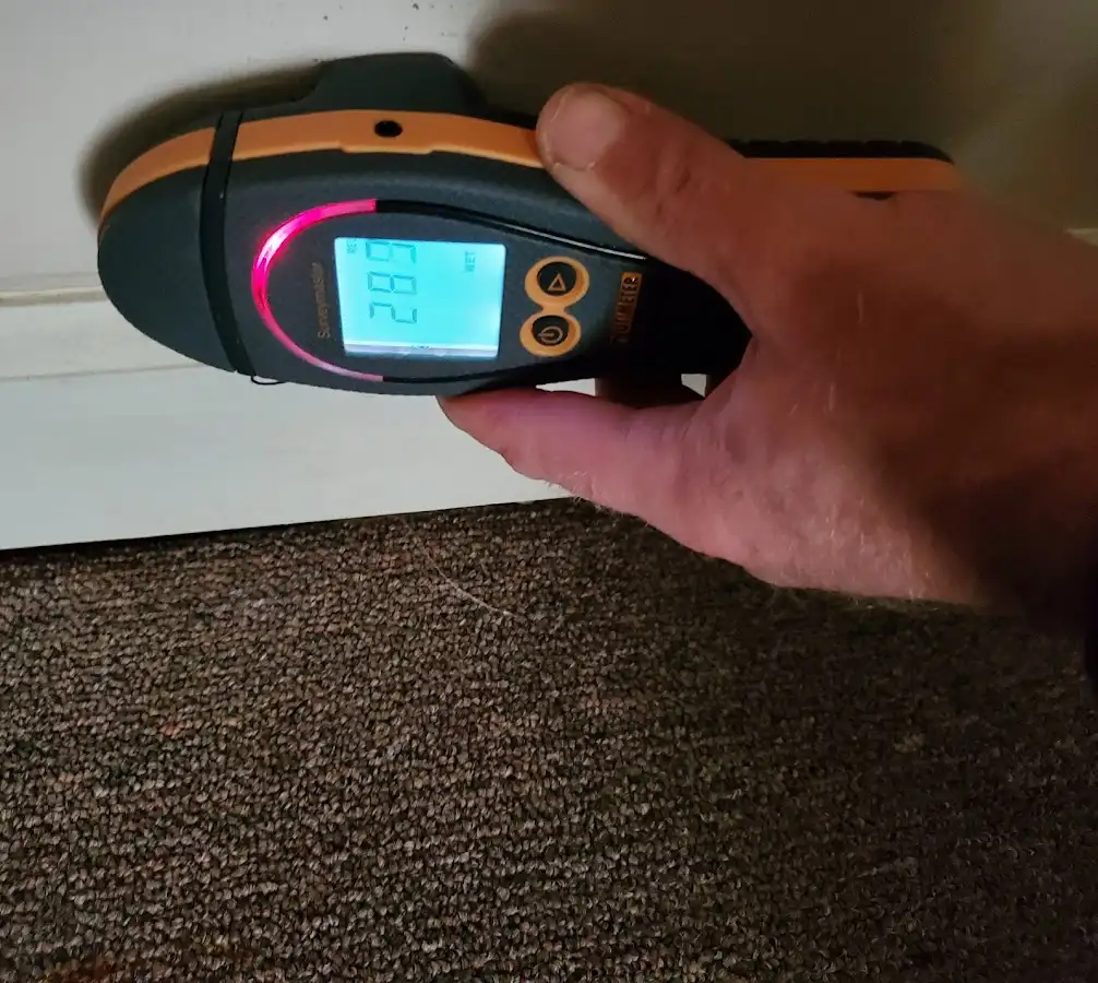 Moisture detection at baseboard during Storm Damage Restoration in Palmdale